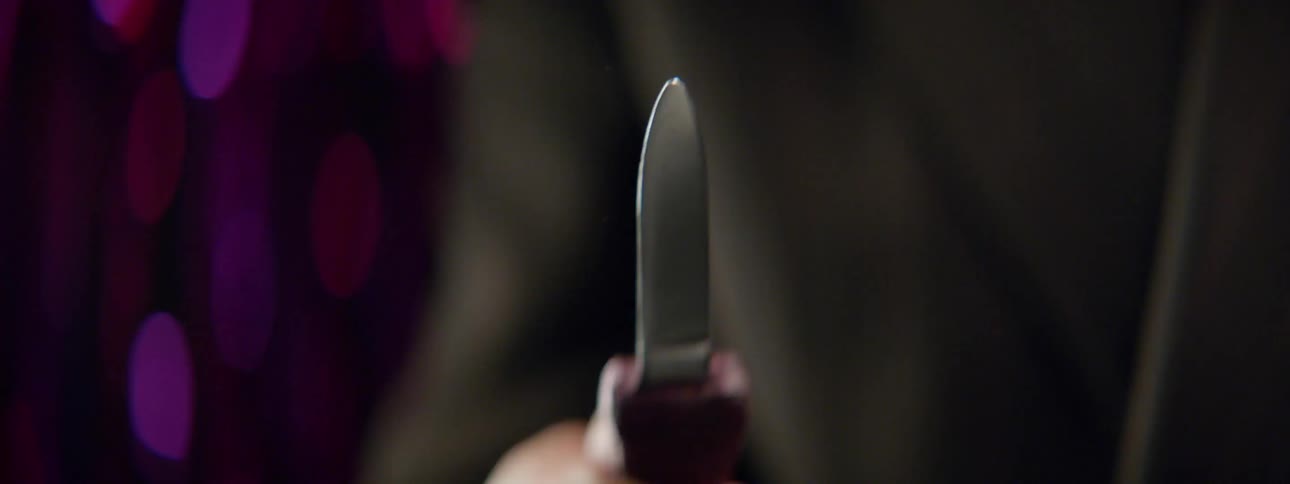 A person is flicking the blade on a switchblade knife