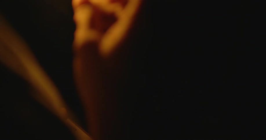 A person lights a cigarette with a match