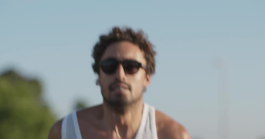 A man is jogging outside on a sunny day