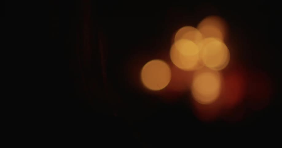 A person is near light from a campfire glowing at night
