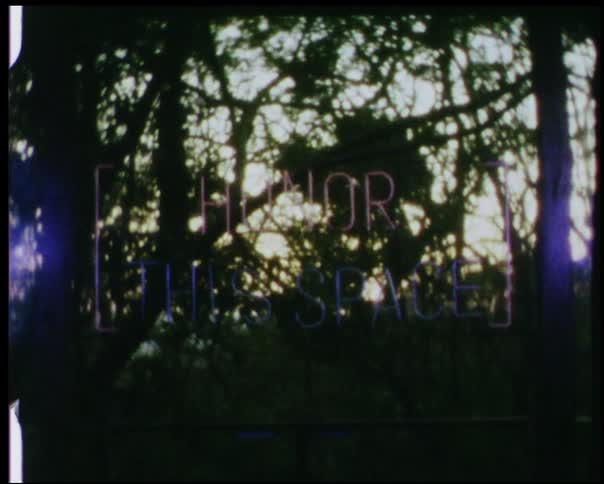A sign flashes outside at sunset
