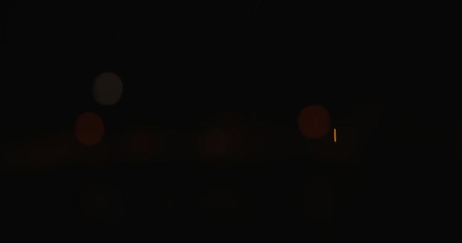 Sparks are rising up from a campfire at night