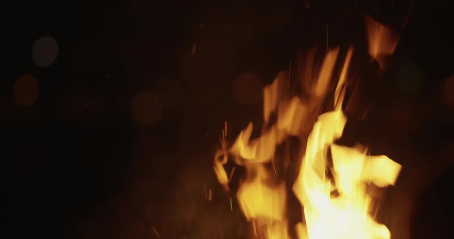 A fire burns in the night air