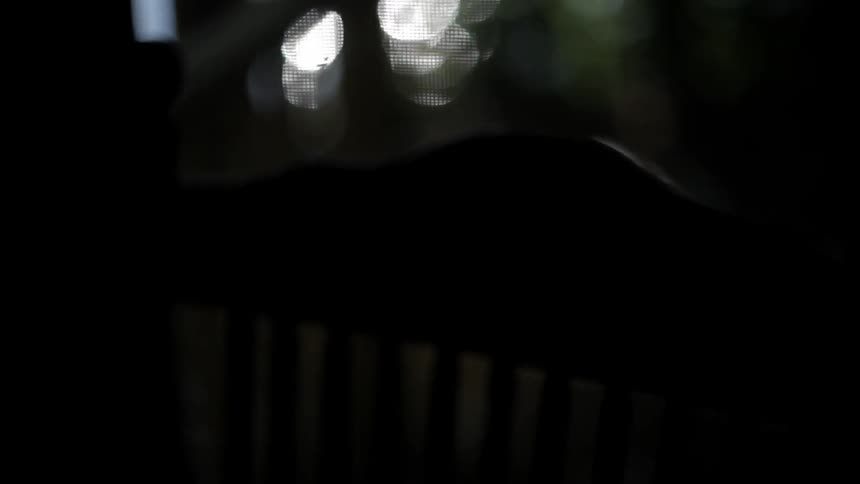 A rocking chair is rocking back and forth