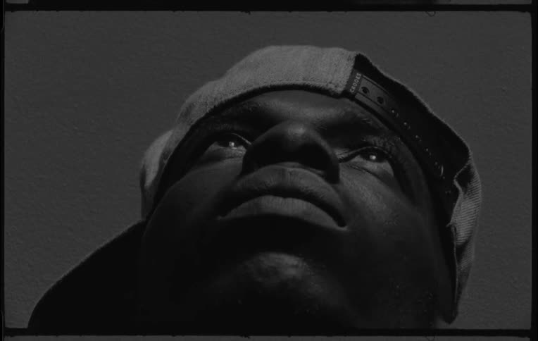 A man opens his eyes and moves his head