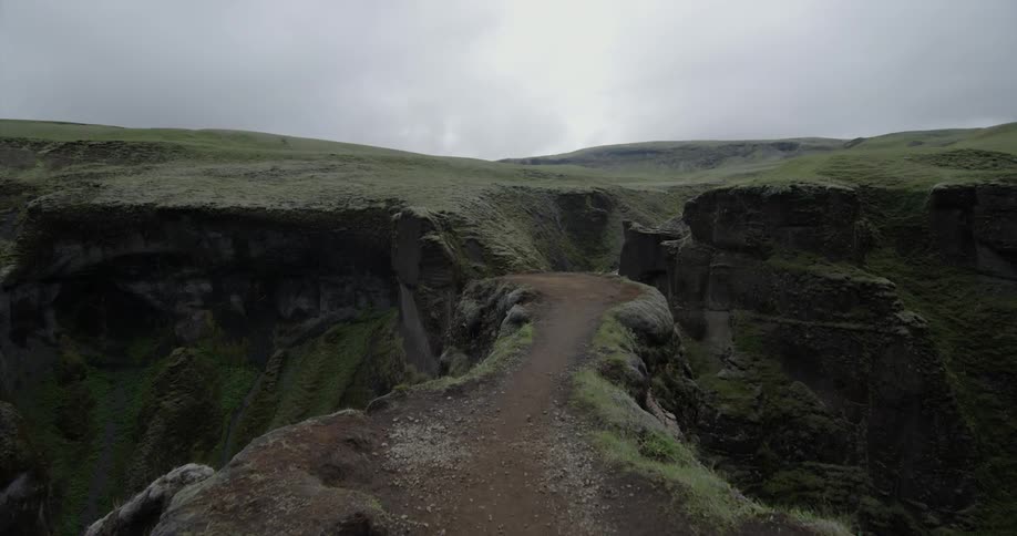 A narrow trail ends at a rocky cliff