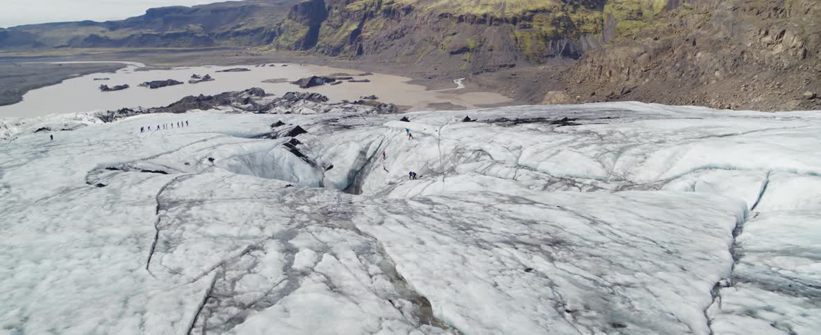 People walk across an icy mountain