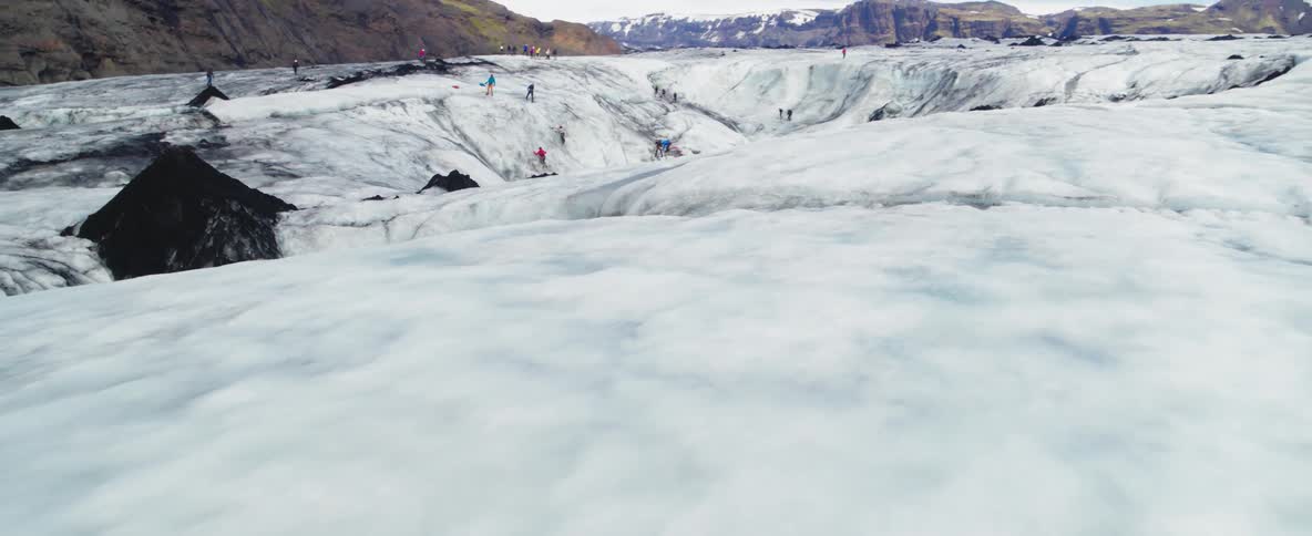 People climb an ice shelf