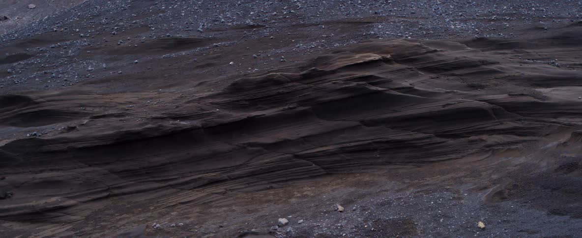 Rocks dot a barren mountain landscape