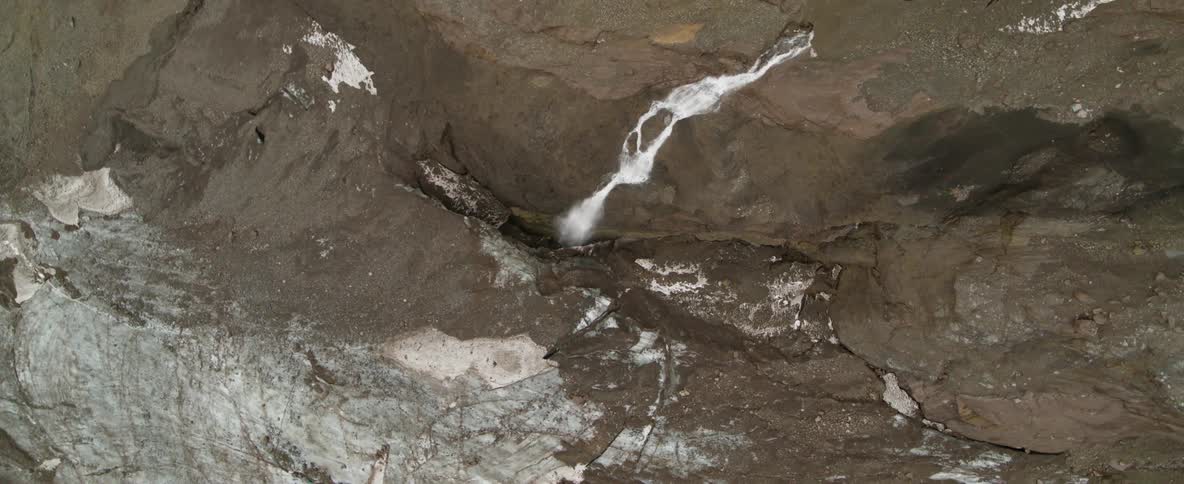 A stream cascades over the landscape during the day