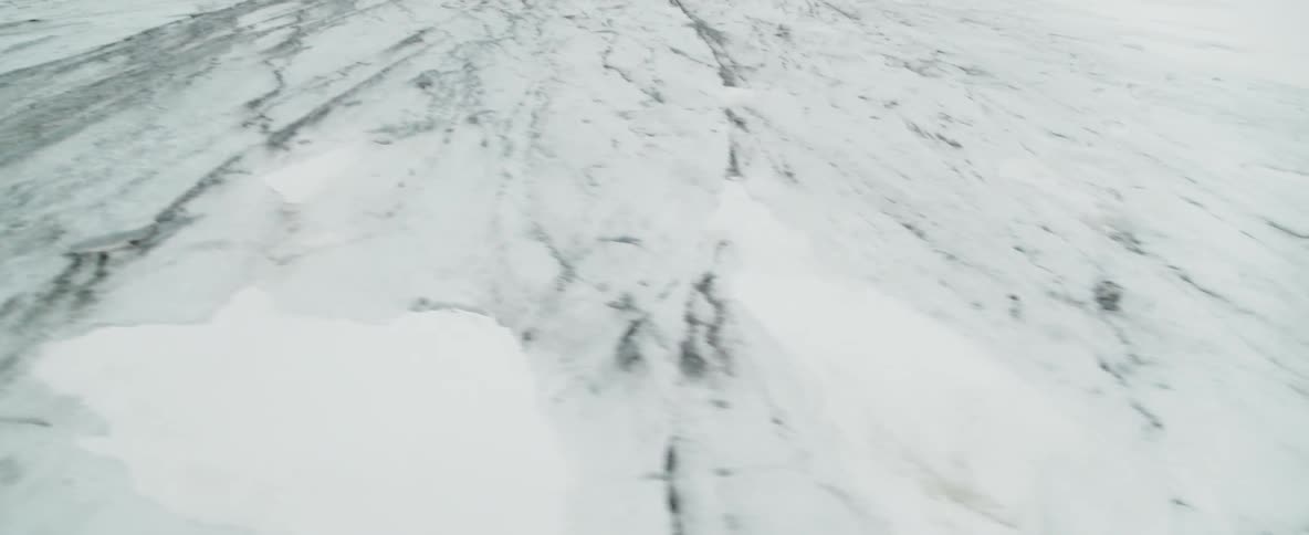 Fog covers a glacier landscape during the day