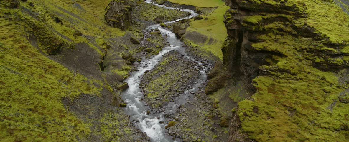 A narrow stream winds down a rocky slope
