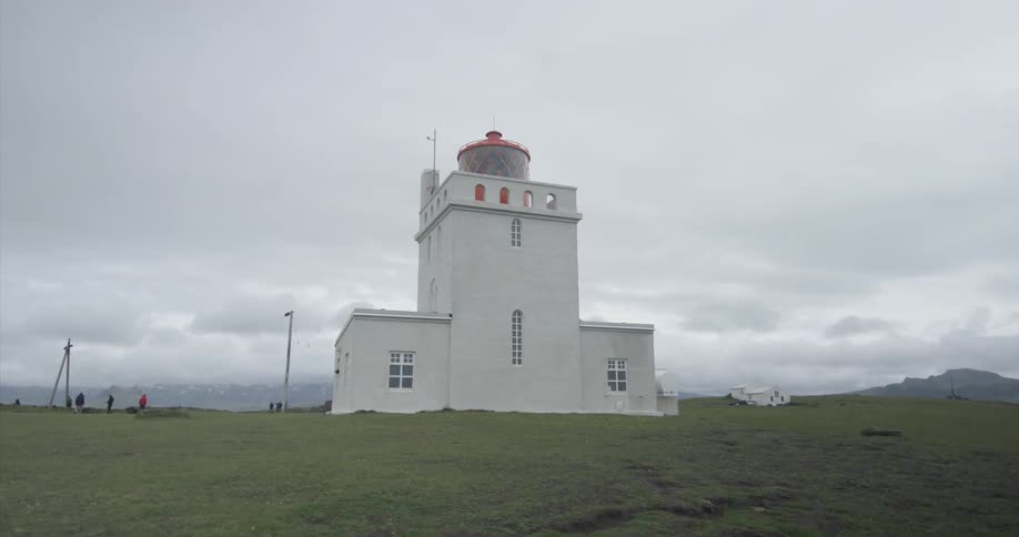 A white building sits on the top of a mountain
