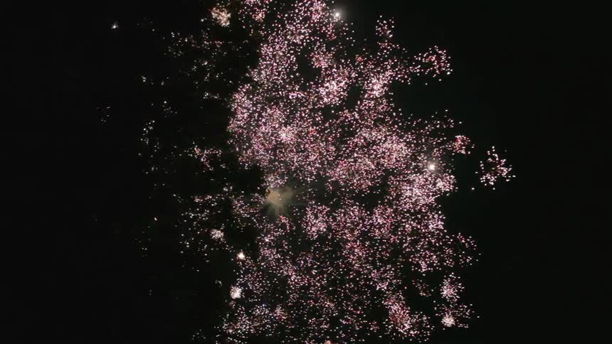 A firework explodes in the night sky