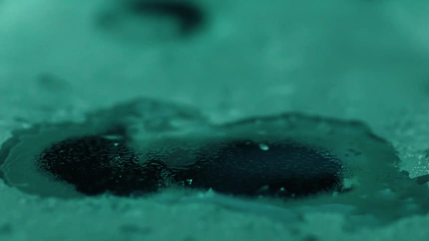 Water drips on a frozen surface