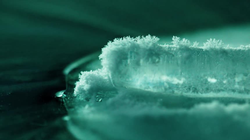 Ice crystals are forming on a windblown surface