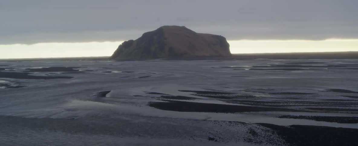 The tide flows rapidly through partially frozen waters