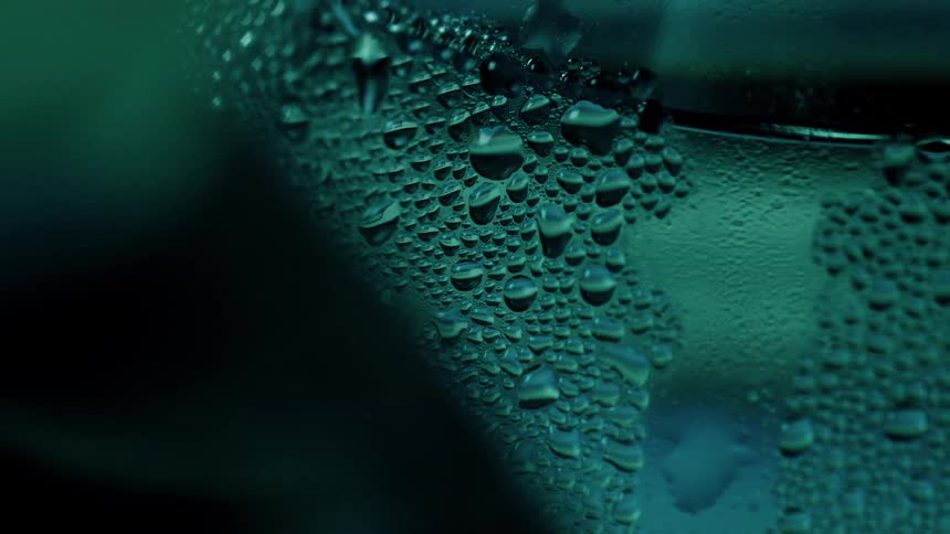 Condensation is pooling on a glass surface