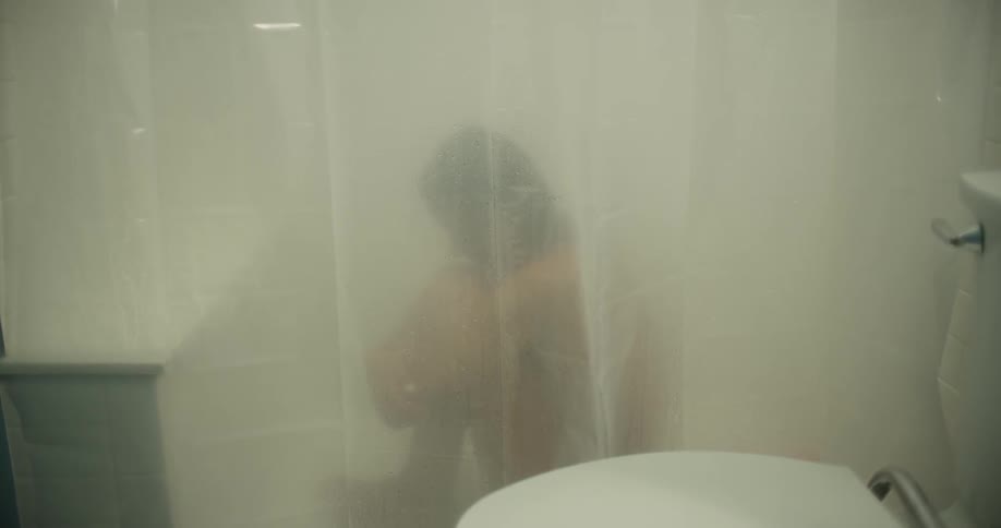 A woman rocking back and forth in the shower