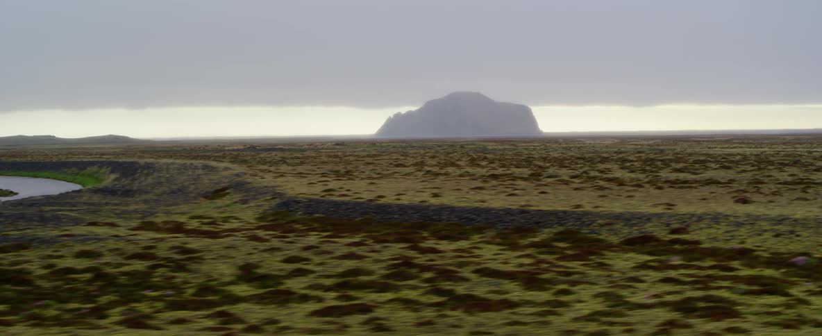 Large rock formation in the distance on a cloudy day
