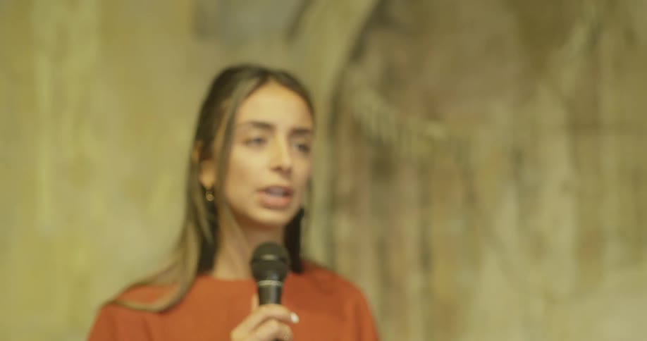 A woman speaks into a microphone