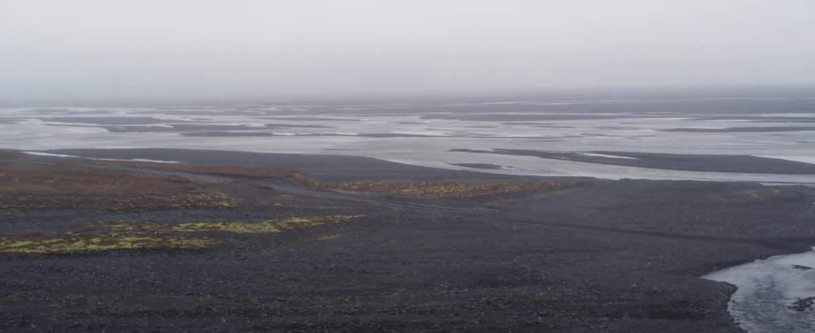 Streams are flowing into the ocean via wetlands on a cloudy day