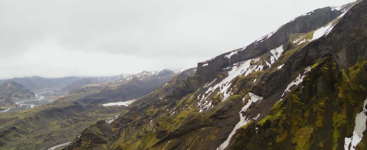 Snow and ice patches on a rocky mountain slope