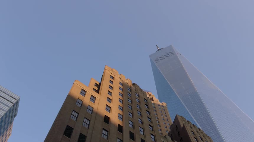 City skyscrapers tower overhead on a clear day