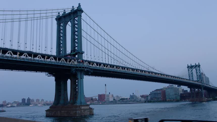Bridge spanning a river near a large city
