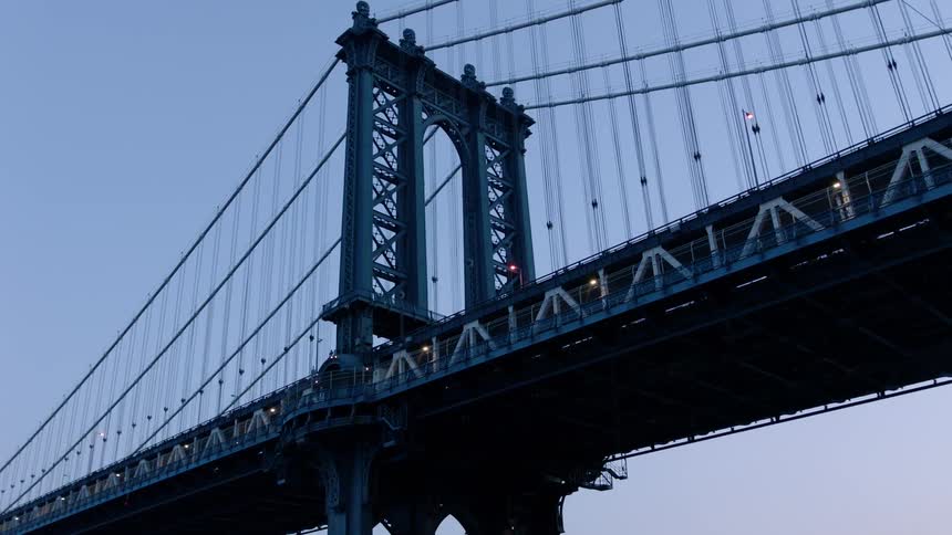 A bridge stands in a city at sunset