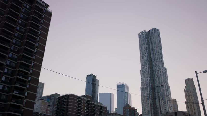 Skyscrapers dominate the skyline of a city at dawn