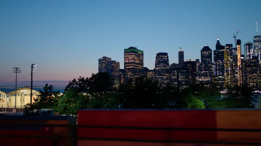 Tall city buildings illuminate the night sky