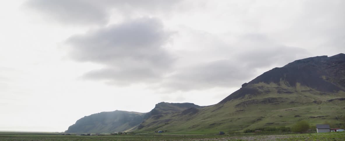 Clouds hang above the mountains