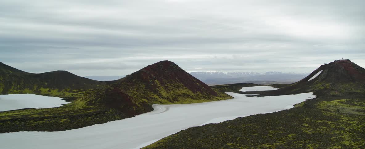 Snow lingers on a mountain plateau on a cloudy day
