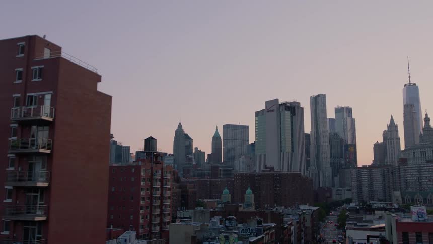 A city with many tall buildings at sunset
