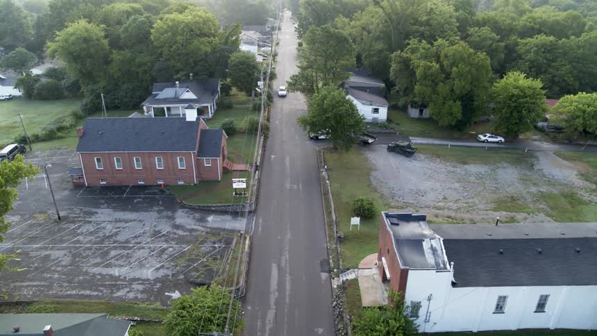 Vehicles drive down the roads of the town