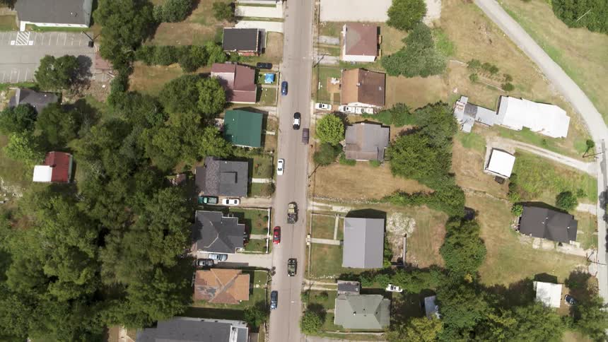 Vehicles travel down a town road