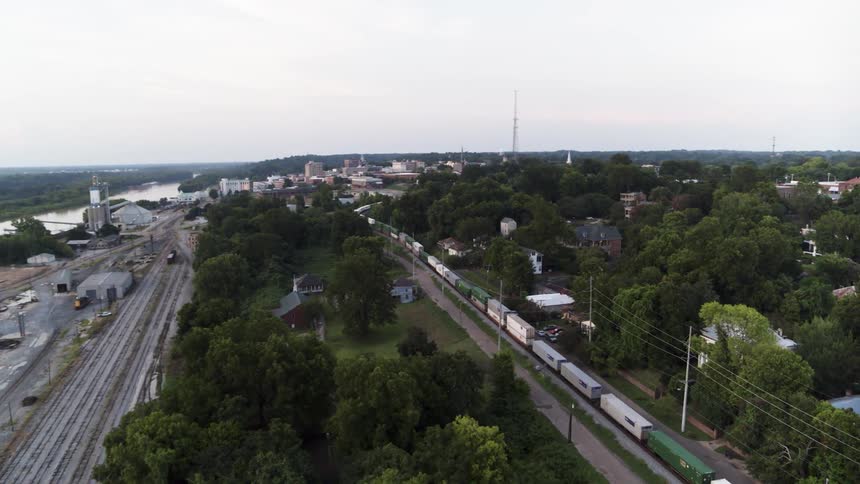 A train pulls cars along the tracks