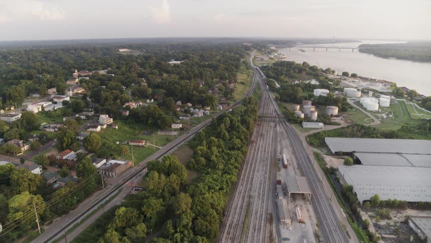 Railroad tracks stretch around a station and along the coast