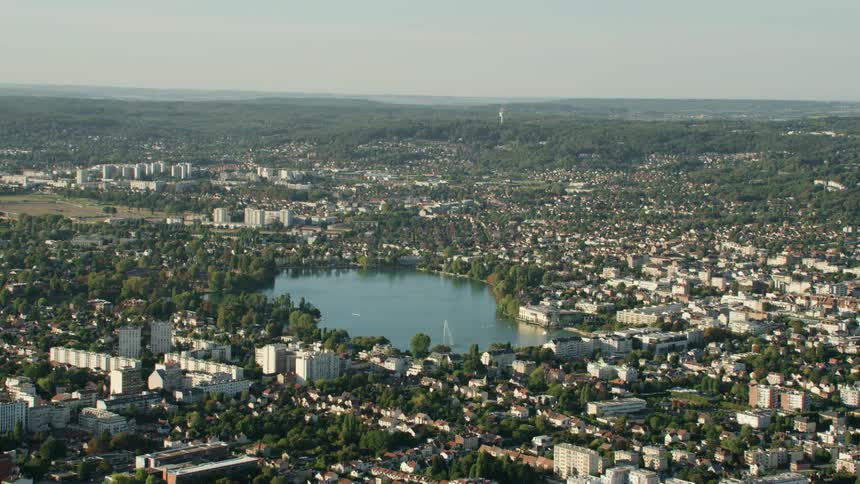 City buildings surround a lake on a clear day