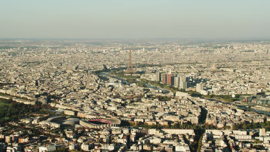 The eiffel tower dominates the skyline in a city on a smoggy day