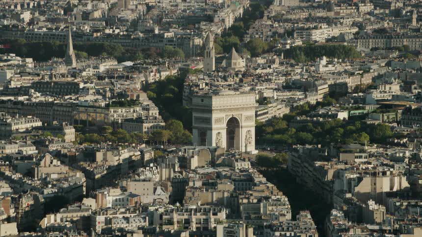Arc de triomphe is standing in the center of Paris during the day