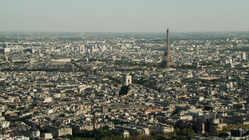 The eiffel tower stands tall above the other city buildings