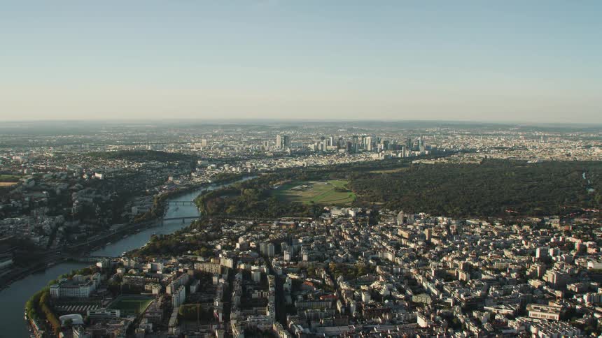 A river runs through the center of this city on a sunny day