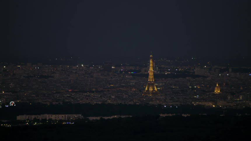 A beam of light emanates from the eiffel tower at night