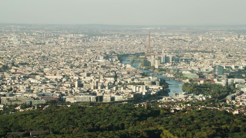 A river flows through a city on a hazy day