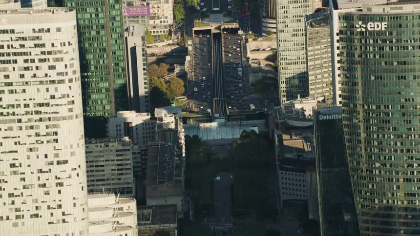 Traffic moves on city streets on a sunny day