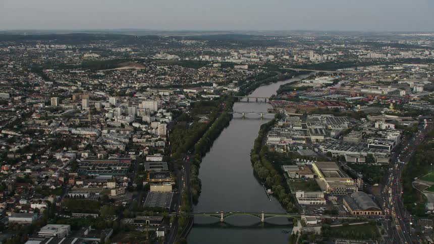 A large city is split down the middle by a small river