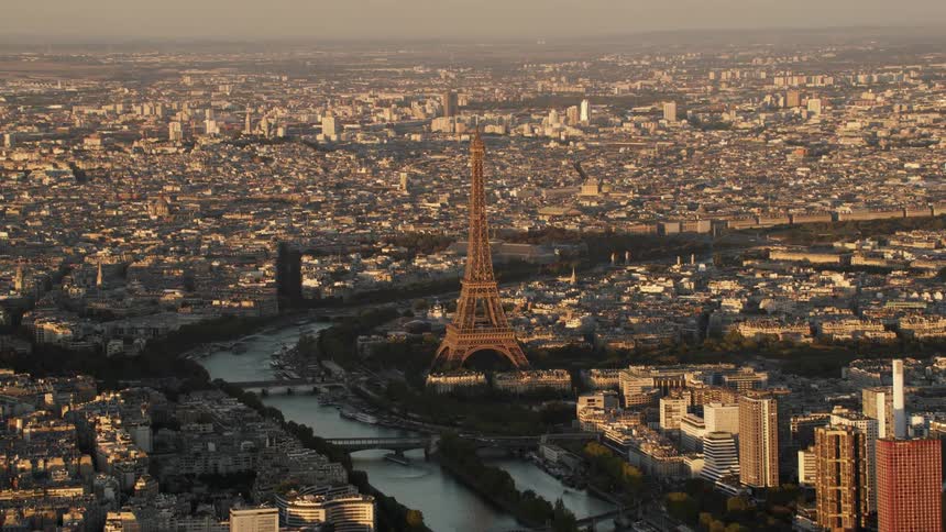 The seine river is flowing past the eiffel tower on a smoggy day