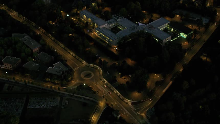 A drone flies over a busy part of town at night